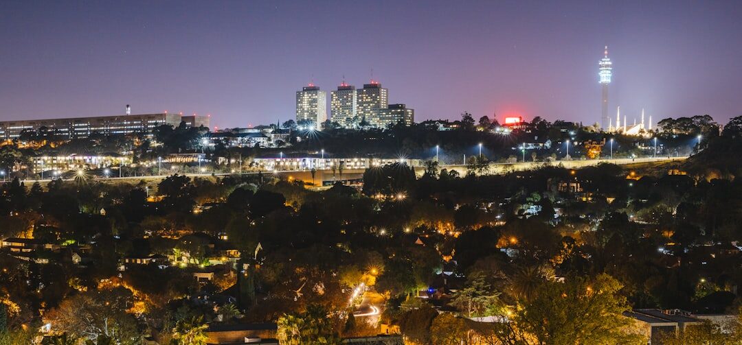 Johannesburg business district skyline at dusk with glowing office towers